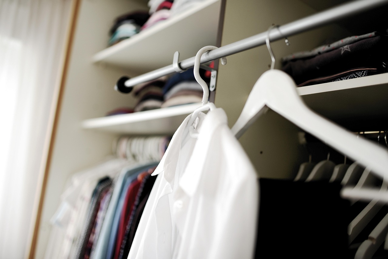 A well-organized closet with hanging clothes