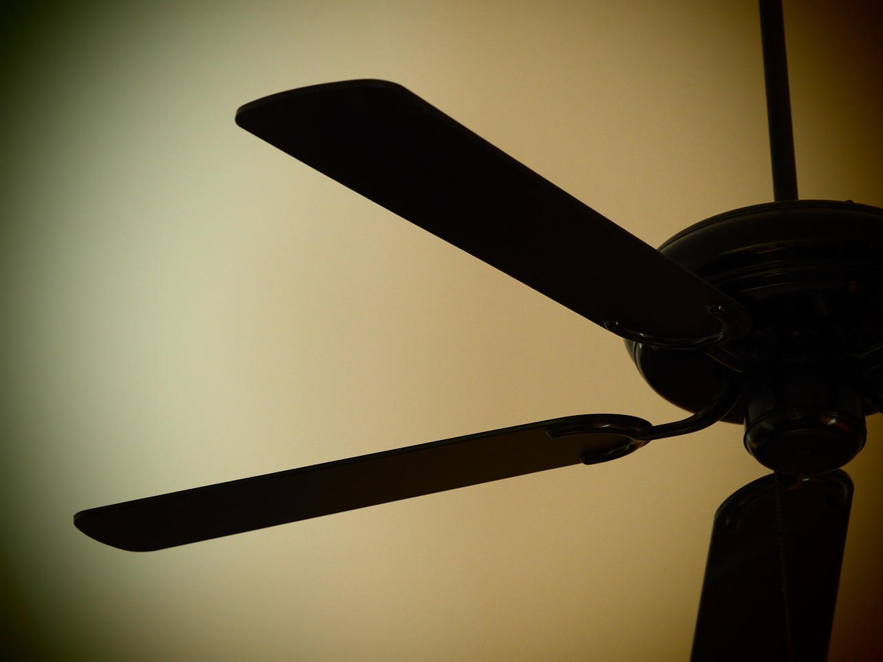 A ceiling vent grille next to a bathroom fan